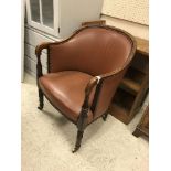 A circa 1900 tub chair with leatherette upholstery and mahogany show frame,