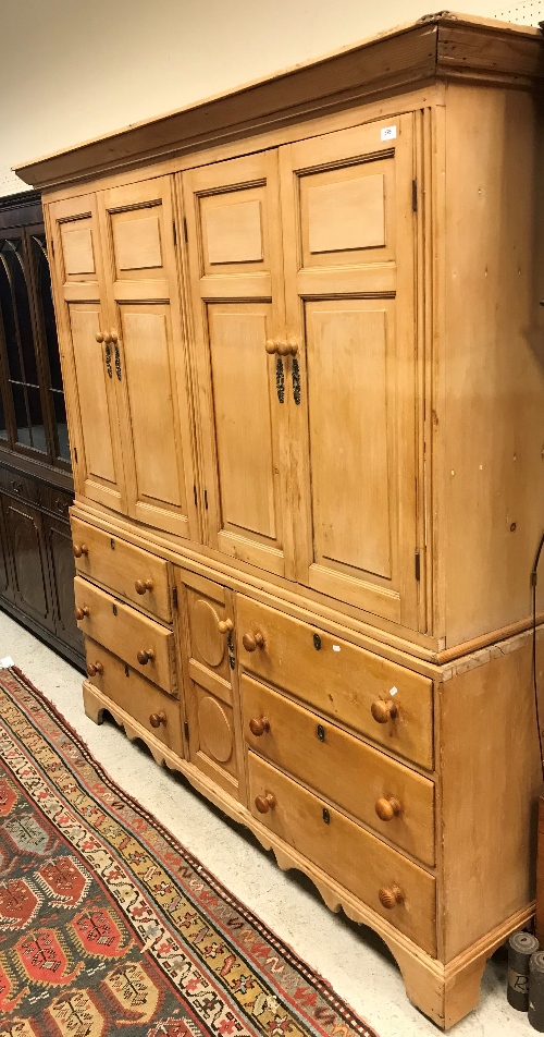 A 19th Century pine housekeeper's cupboard with two pairs of fielded panel cupboard doors over a