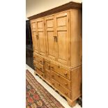 A 19th Century pine housekeeper's cupboard with two pairs of fielded panel cupboard doors over a