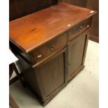 A late Victorian oak side cabinet, the plain top above two short and two cupboard doors,