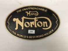 A modern painted cast metal sign "The Unapproachable Manx Norton - The World's Best Road Holder"