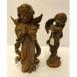 A cast iron figure of a praying angel and a cast iron figure of a cherub with butterfly on arm