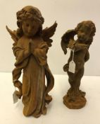 A cast iron figure of a praying angel and a cast iron figure of a cherub with butterfly on arm