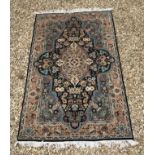 A Persian design rug with centre medallion on a blue black ground,