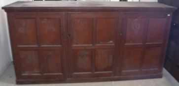 A late 19th century continental stained pine housekeeper's cupboard with 3 cupboard doors 280 cm