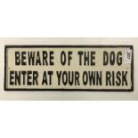 A painted cast metal sign "Beware Of The Dog Enter At Your Own Risk"