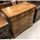 A George III fruitwood chest of two short and three long graduated drawers on bracket feet,