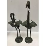A pair of verdigris patinated bronze figures of Cranes in the Japanese style,