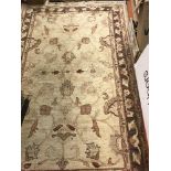 A Ziegler design carpet, the central panel set with foliate design on a cream ground,