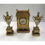 A late 19th Century clock garniture in the Aesthetic taste,