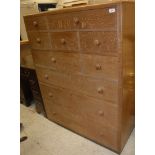 A Betty Joel oak chest of seven various short over three long drawers with shell carved handles