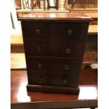 A miniature mahogany chest of 4 long drawers in the early 19th century manner 32.5 cm wide x 43.