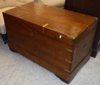 A 19th Century brass bound teak military style trunk with interior of various pull-out drawers,