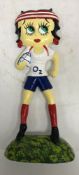 A modern painted cast iron doorstop "Betty Boo Playing Rugby"