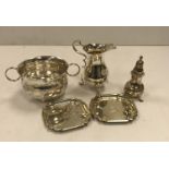 A collection of silver comprising twin-handled porringer, a baluster shaped cream jug,