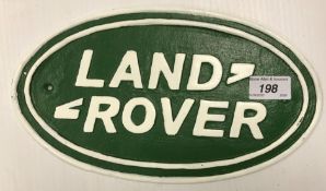 A painted cast metal "Landrover" sign