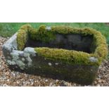 A rectangular natural stone trough with shallow D end,