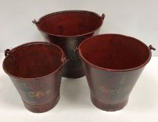 A graduated set of three vintage style painted metal buckets inscribed "Coca Cola"