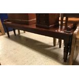 A mahogany window seat in the Victorian manner, the plain top with turned and ringed side handles,