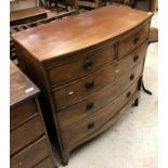 A Victorian mahogany bow front chest of two short over three long graduated drawers on bracket feet,