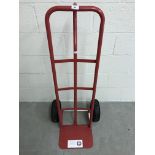A modern red painted sack barrow