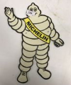 A modern painted cast metal sign "Michelin Man"