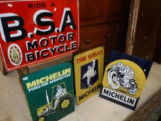 A collection of four reproduction metal signs including "Ride a B.S.A.