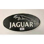A painted cast metal "Jaguar" sign