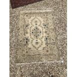 A Kashan rug with central lozenge medallion on a cream ground,