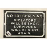 A painted metal sign inscribed "No Trespassing - Violators Will Be Shot.