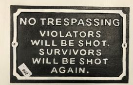 A painted metal sign inscribed "No Trespassing - Violators Will Be Shot.