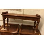 An oak window seat in the Victorian manner with turned end rails over a plank seat on turned and