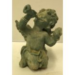 A verdigris patinated iron figure of a cherub blowing a horn