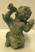 A verdigris patinated iron figure of a cherub blowing a horn