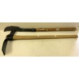 A wooden handled iron mattock and slasher with iron blade and long handle