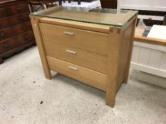 A modern oak chest of three long drawers with glass top, together with associated double bedstead,