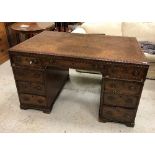 A 19th Century mahogany partner's desk, the top with tooled leather insert within a moulded edge,