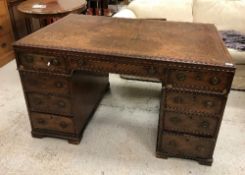 A 19th Century mahogany partner's desk, the top with tooled leather insert within a moulded edge,