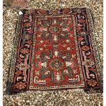 Two Heriz rugs, one with central panel with two repeating medallions on a red ground, within a blue,