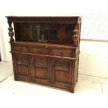 An Old Charm oak and leaded glazed court cupboard with two doors over three drawers and three