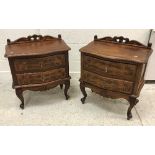 A pair of modern mahogany serpentine fronted chests with carved decoration in the Louis XV taste,