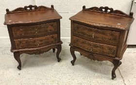 A pair of modern mahogany serpentine fronted chests with carved decoration in the Louis XV taste,