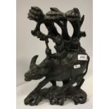 A Chinese carved hardwood and silver wire inlaid figure of a water buffalo with figures upon its