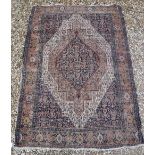 A Caucasian rug with blue stylised medallion decorated lozenge shaped medallion on a fawn / cream