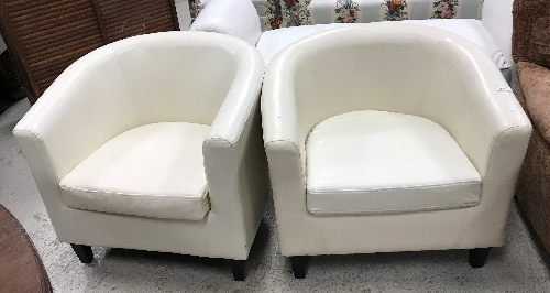 A near matching pair of modern Italian cream leather upholstered tub chairs on square tapered