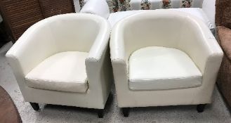 A near matching pair of modern Italian cream leather upholstered tub chairs on square tapered