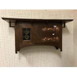 An oak, leaded glazed and copper embellished wall cabinet in the manner of Liberty of London,