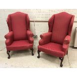 A pair of modern upholstered wing back scroll arm chairs in the George III taste,