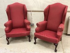 A pair of modern upholstered wing back scroll arm chairs in the George III taste,