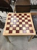 A modern French beech and stained beech chess table,